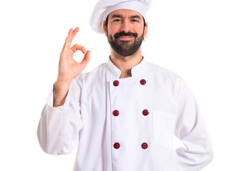 Chef making Ok sign over white background